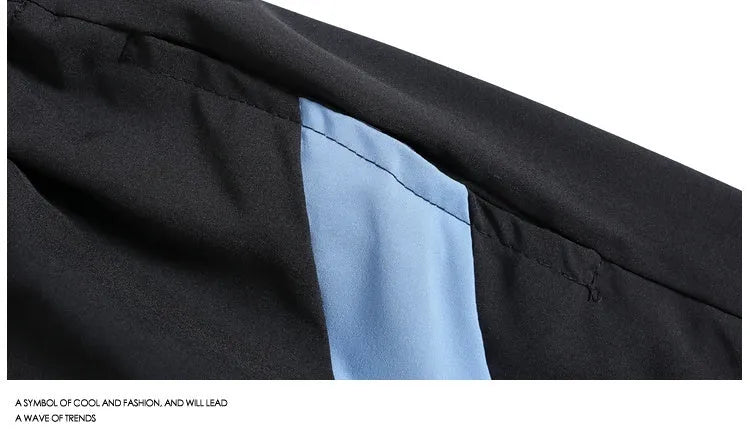 Men's black loose-fit quick-drying sports shorts with elastic waistband on a grey background