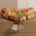 Natural green jade multi-layer wrap bracelet for women with a silver orchid pendant charm.