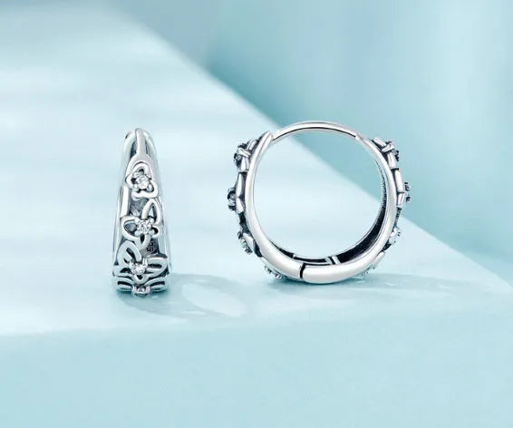 Sterling silver S925 retro hollow butterfly earrings with zircon details on a white background.