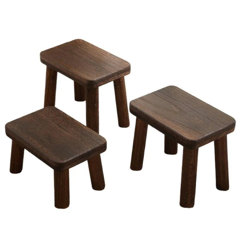 Solid wood shoe changing stool with distressed finish and bracket structure in a living room setting