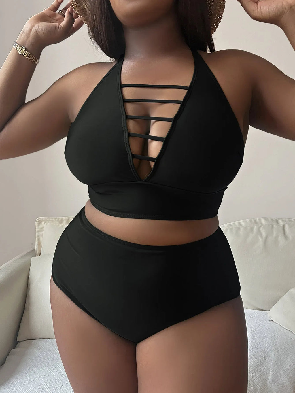 Plus size woman modelling a black adjustable halter bikini with high waist briefs