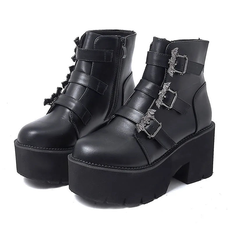 Black women's punk ankle boots with bat buckle, side zipper, thick heel, and round toe.