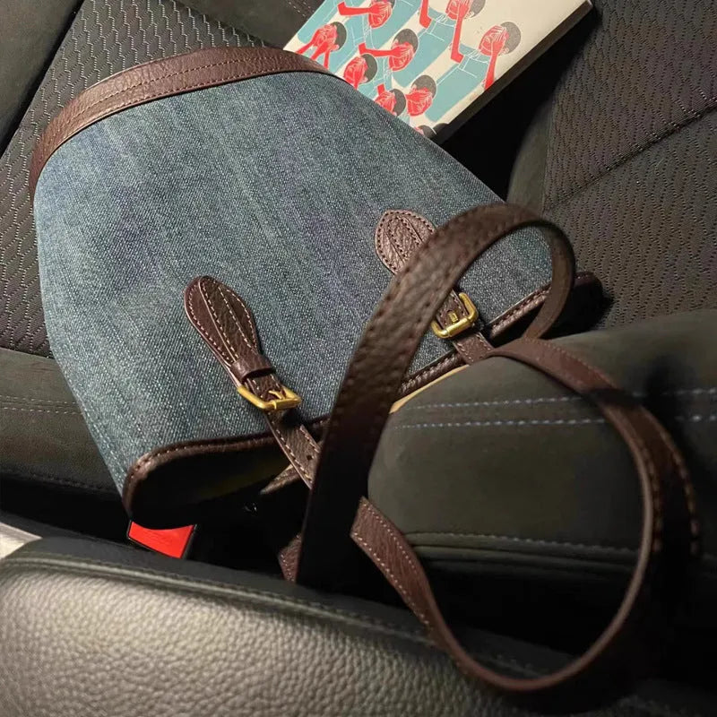 Denim patchwork bucket handbag with one-shoulder strap showing 23x27x16cm dimensions