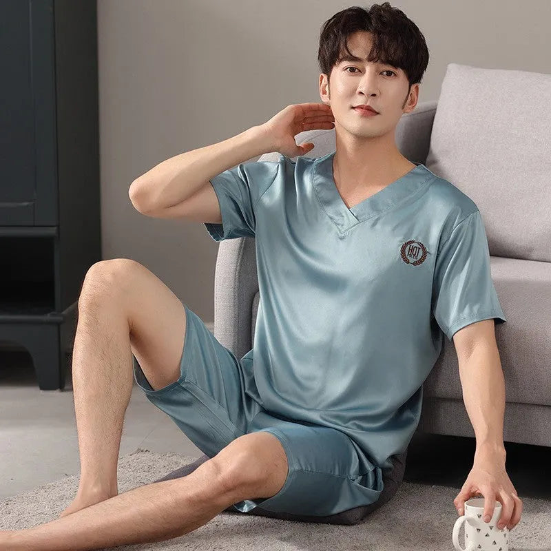 Man wearing a light blue loose-fit ice silk short sleeve pajama shirt and matching shorts.