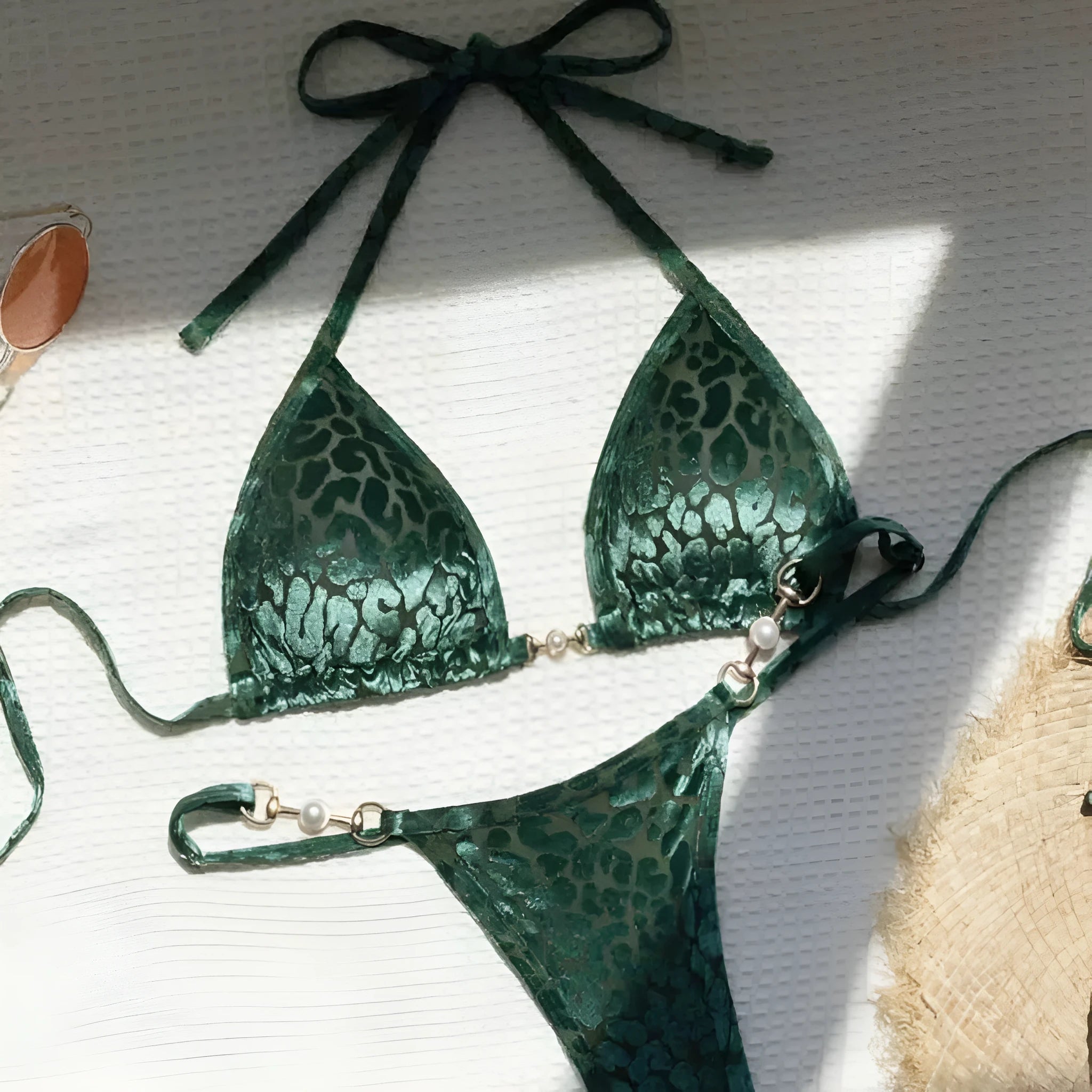 Blue leopard print women's polyester bikini set on a yellow background, showing a T-shaped sleeveless design.