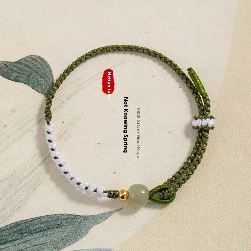 Women's Chinese national bracelet with Hetian jade charm on cord carrying strap