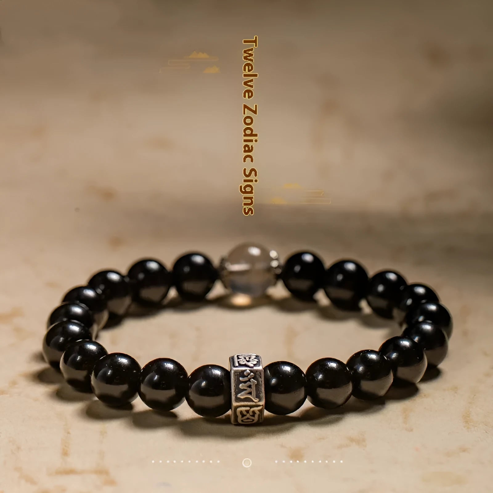 Old Pit Obsidian 8mm bracelet with detailed metal zodiac animal and Buddhist bodhisattva charms.