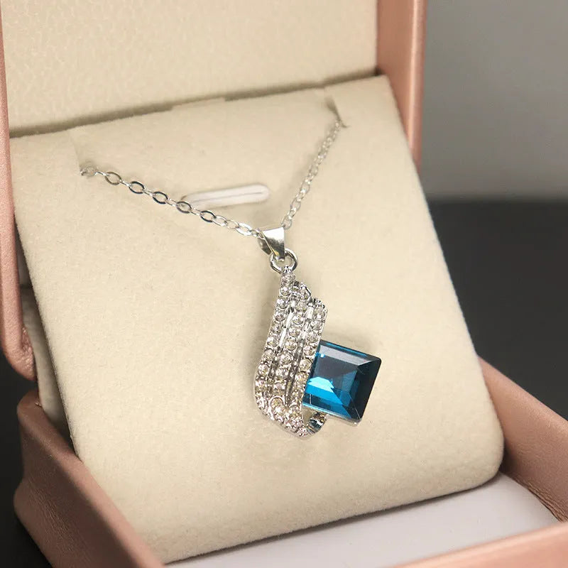 Women's alloy necklace and earring set with glass pendant featuring cross chain design