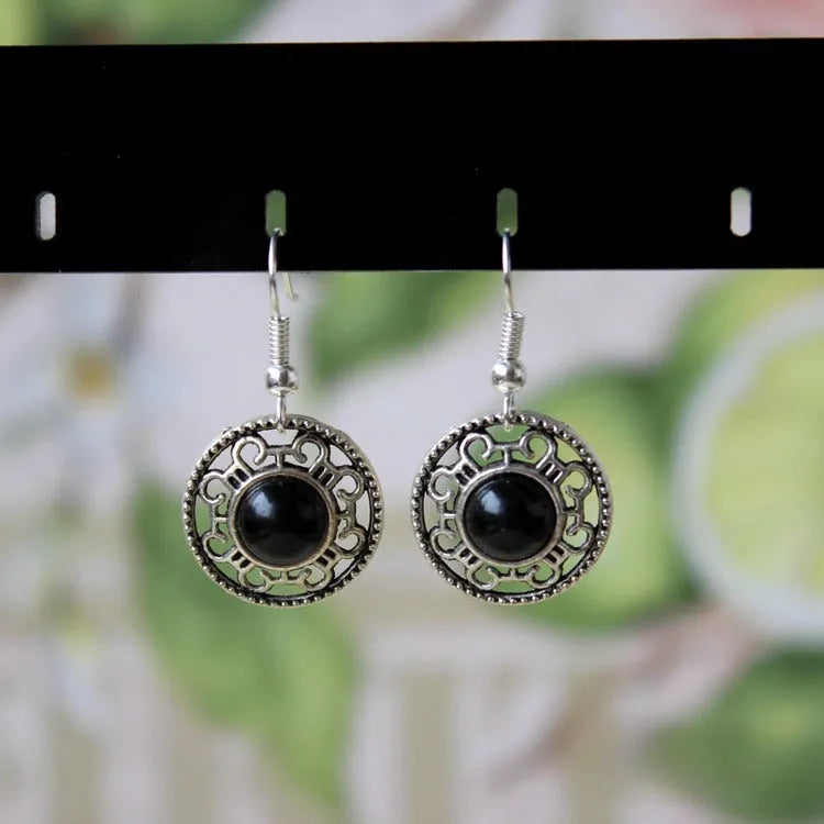 Handmade Miao silver earrings with turquoise flower disk design and ethnic totem patterns in red blue or black colour options