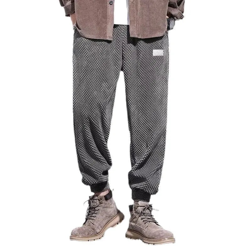 Men's grey straight-leg sweatpants with an adjustable ankle strap, laid flat.