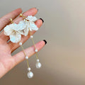 Women's acrylic shell pearl tassel earrings with approximately 8.8cm length and multiple clip options