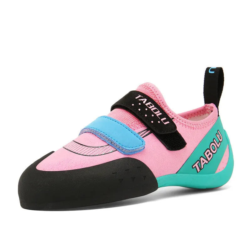 Beginner rock climbing shoes with Velcro strap and rubber sole in black and red colour combination