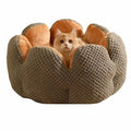 Green cactus petal shaped enclosed pet bed for cats and dogs on a hardwood floor.