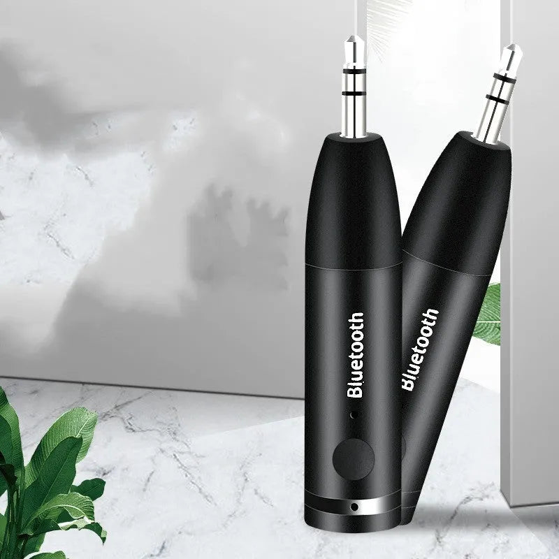 Black Bluetooth 5.0 AUX audio receiver for car stereo with USB charging cable