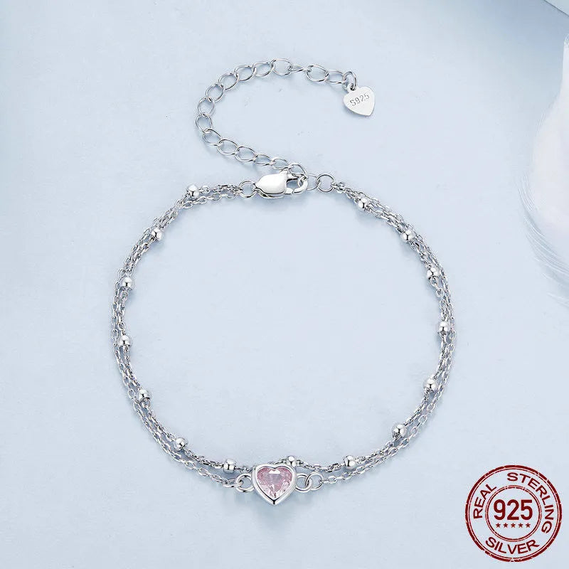 Sweet girlish style 925 sterling silver bracelet with a small heart-shaped charm on a chain.