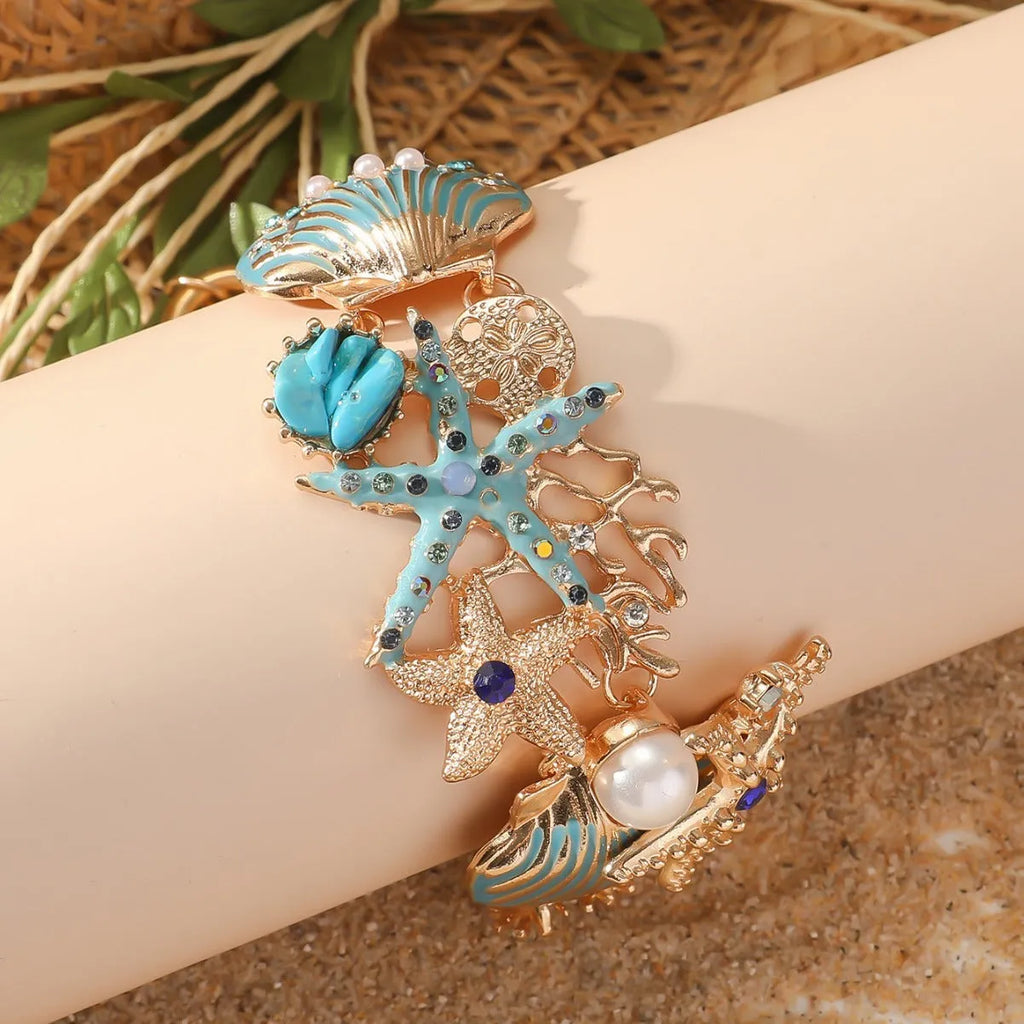 Close-up of a women's alloy starfish rhinestone bracelet in turquoise colour.