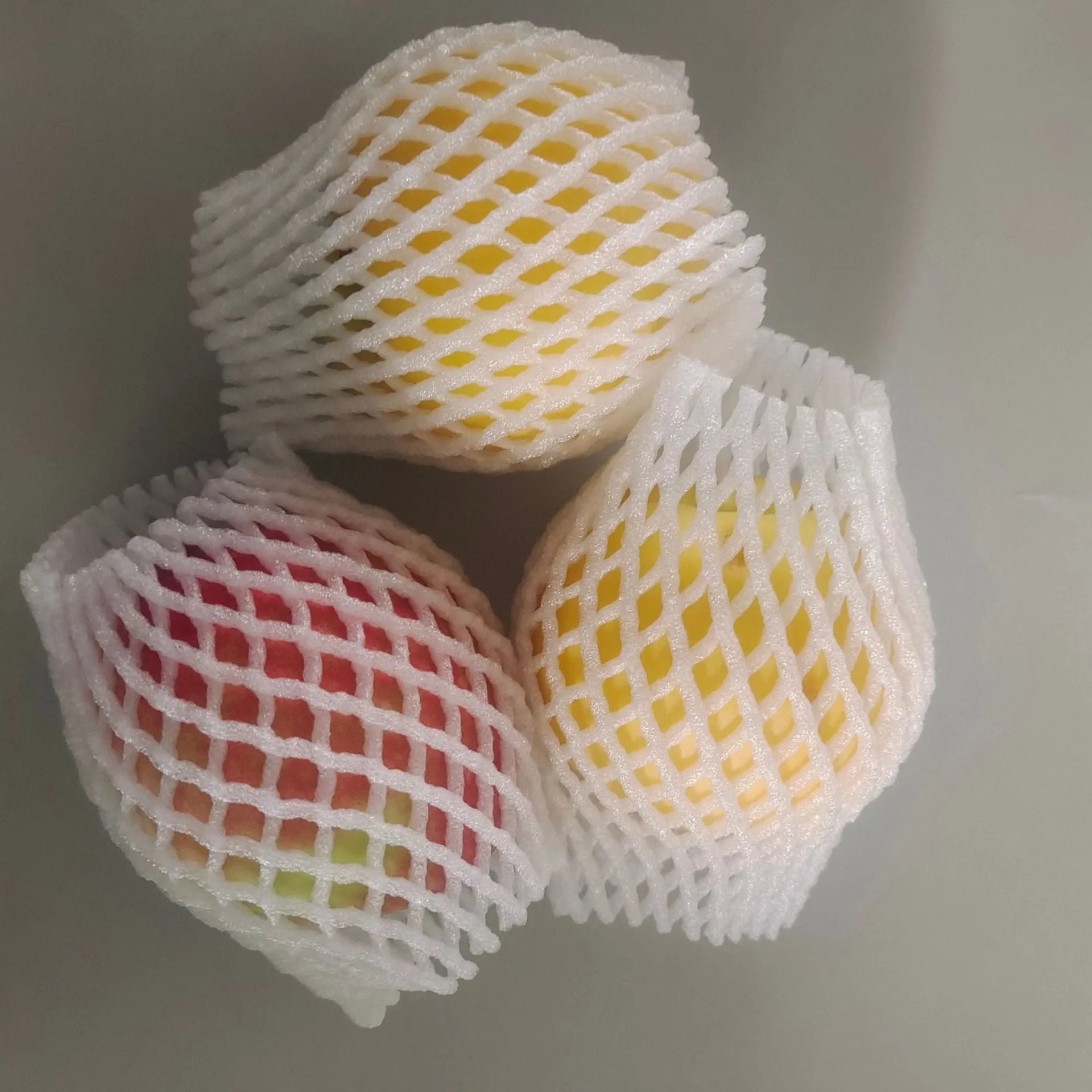 White foam protective net case for fruits showing mesh texture and size options