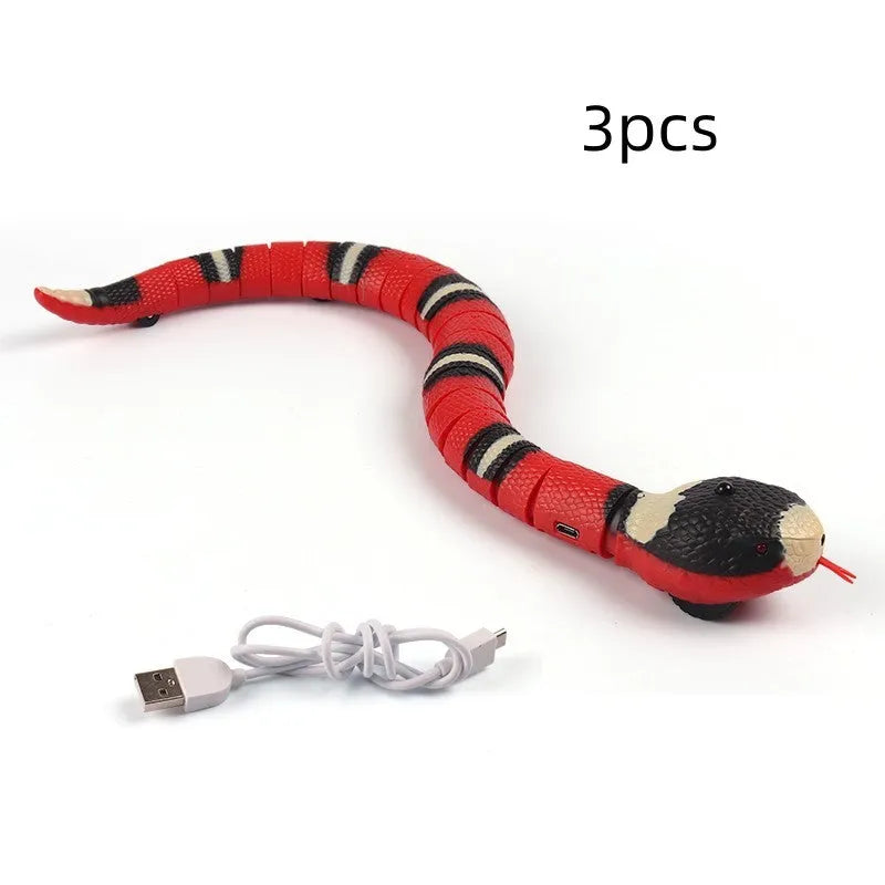 Smart sensing electronic snake cat toy with segmented body on floor