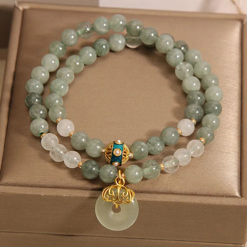 Women's double-layer aventurine jade bracelet in oil green with a safety buckle and rhinestone details.