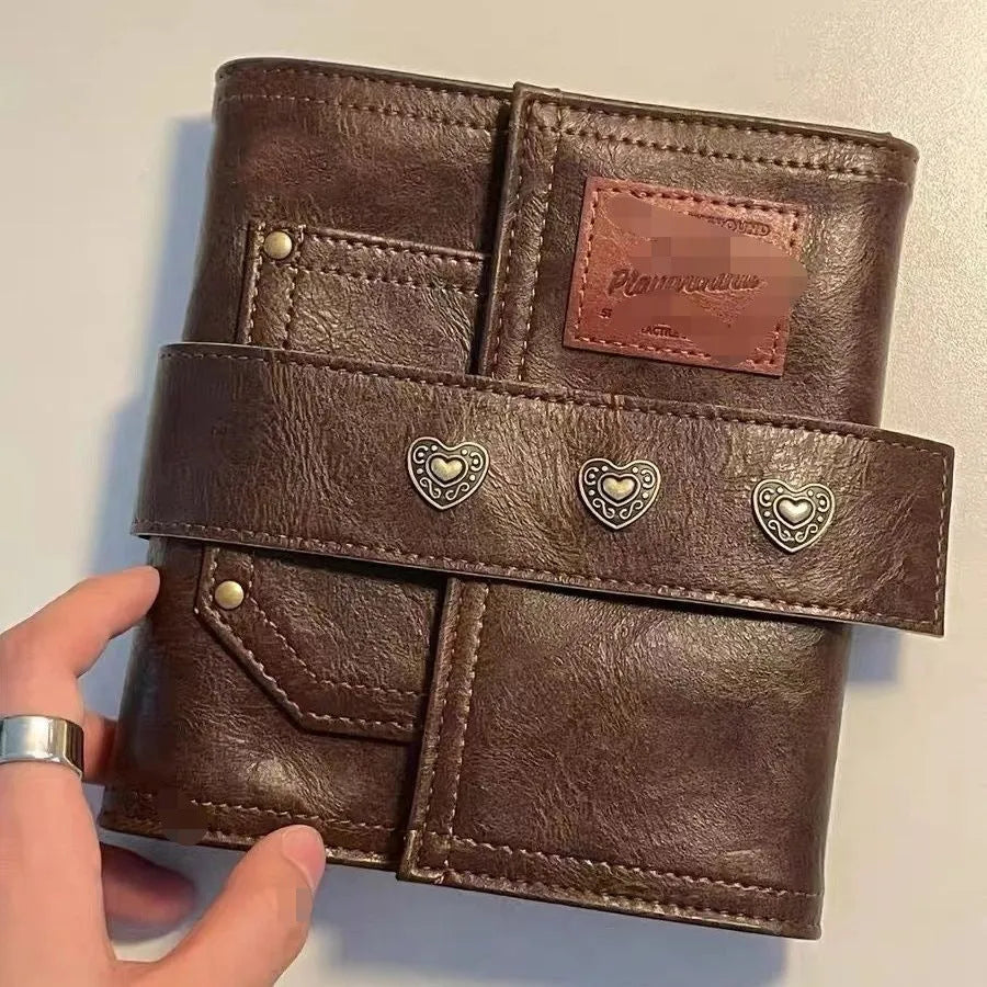 A7 brown PU leather-style notebook with loose-leaf binder binding, open to show 40g raw wood pulp paper