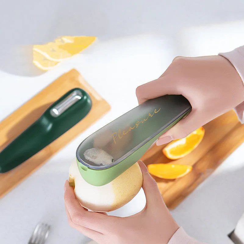 Dark green stainless steel vegetable peeler with integrated storage box and non-slip handle for kitchen use
