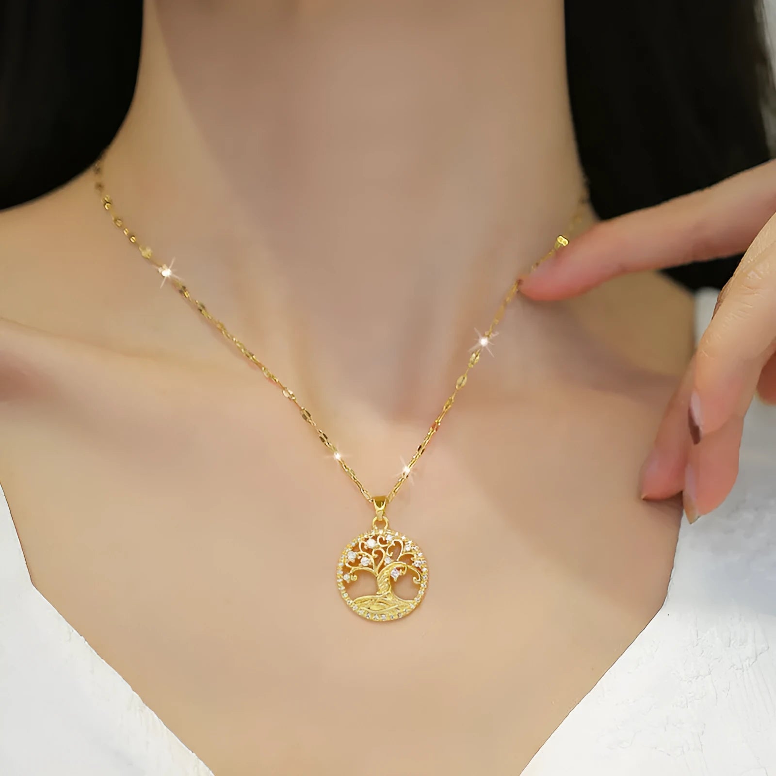 Gold-plated necklace with mother-of-pearl pendant and rhinestone cross design on adjustable lip chain