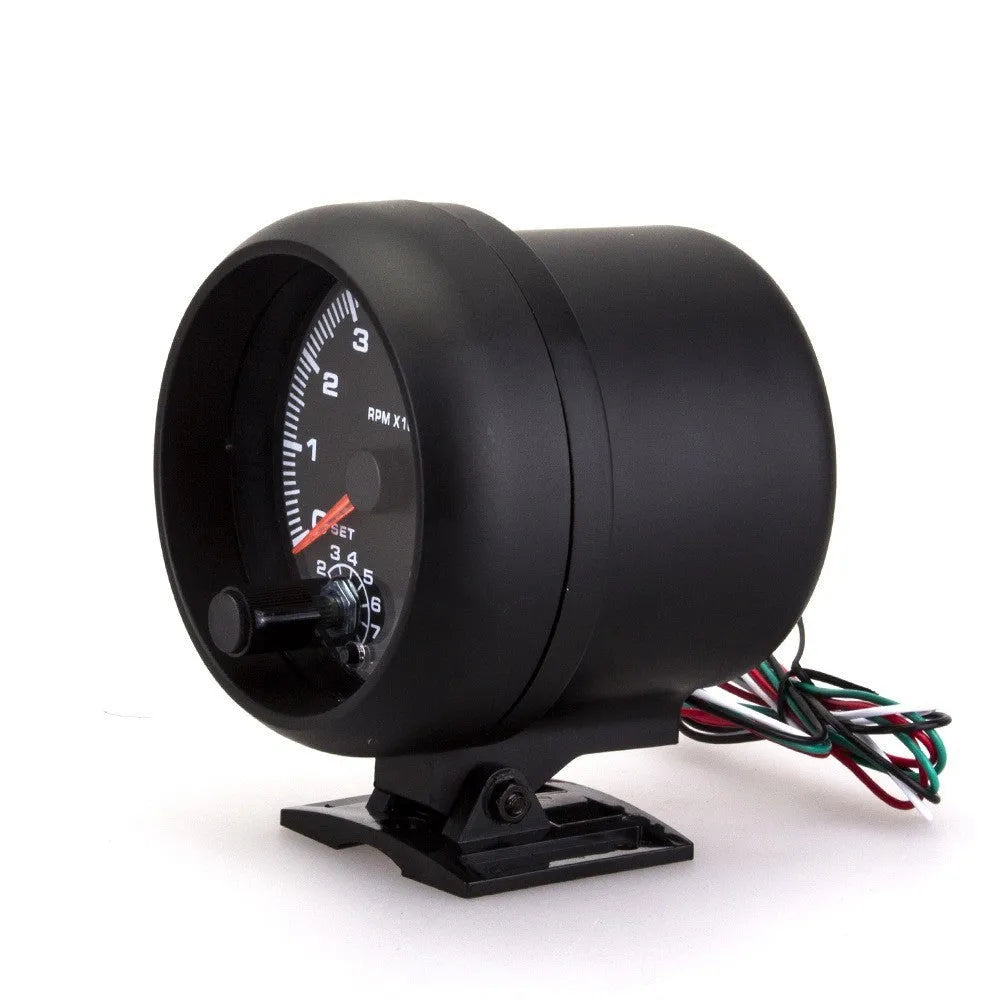 Black universal automotive tachometer with blue light pointer and scale showing rpm.