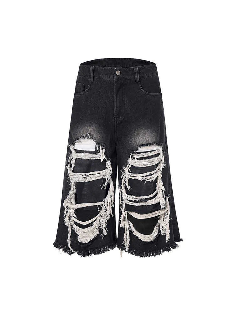 Black cropped wide leg jeans with ripped patch details and mid-high waist