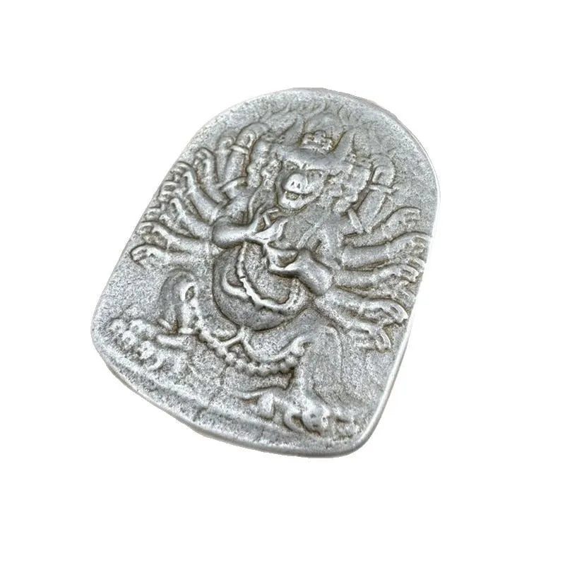 Close-up of an antique iron pendant depicting the Aryaacalanatha Yamantaka icon in a Chinese geometric style.