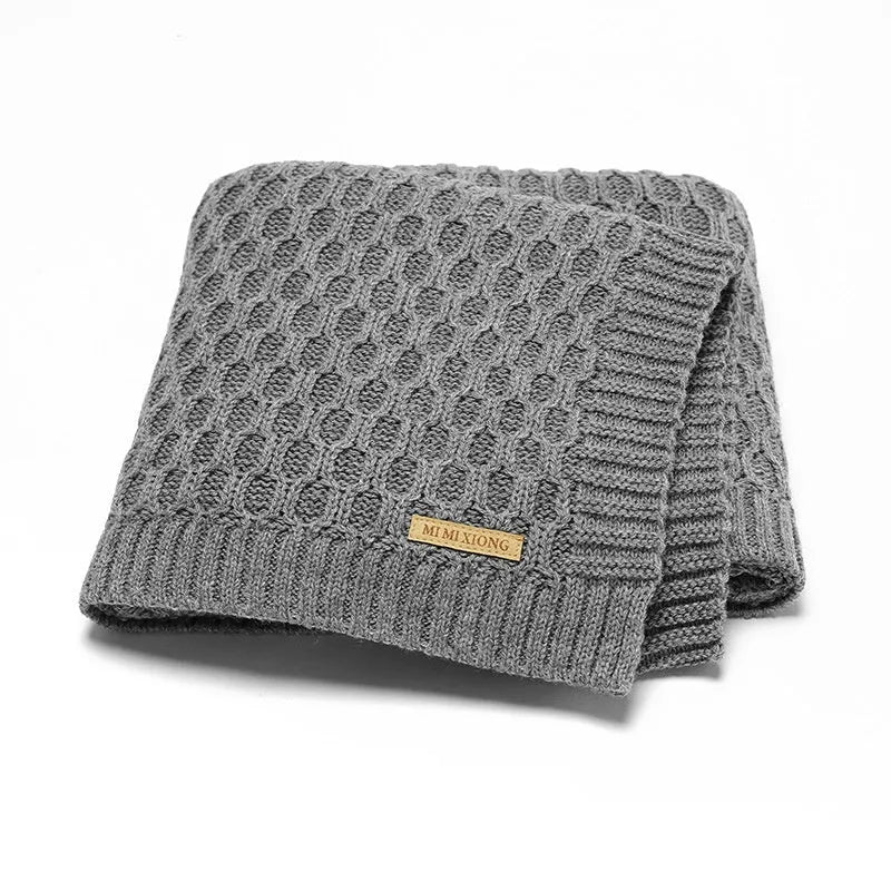 Solid colour infant blanket with raised line texture, shown in a light green colour.