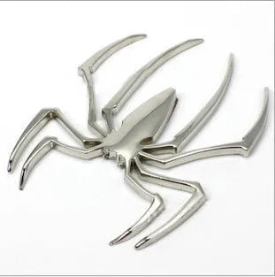 Gold 3D metal spider bumper sticker on a car bumper