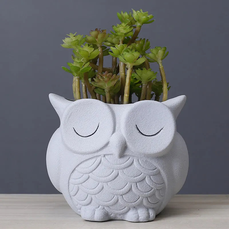 Handmade ceramic owl-shaped succulent plant pot in frosted light pink, shown from the front.