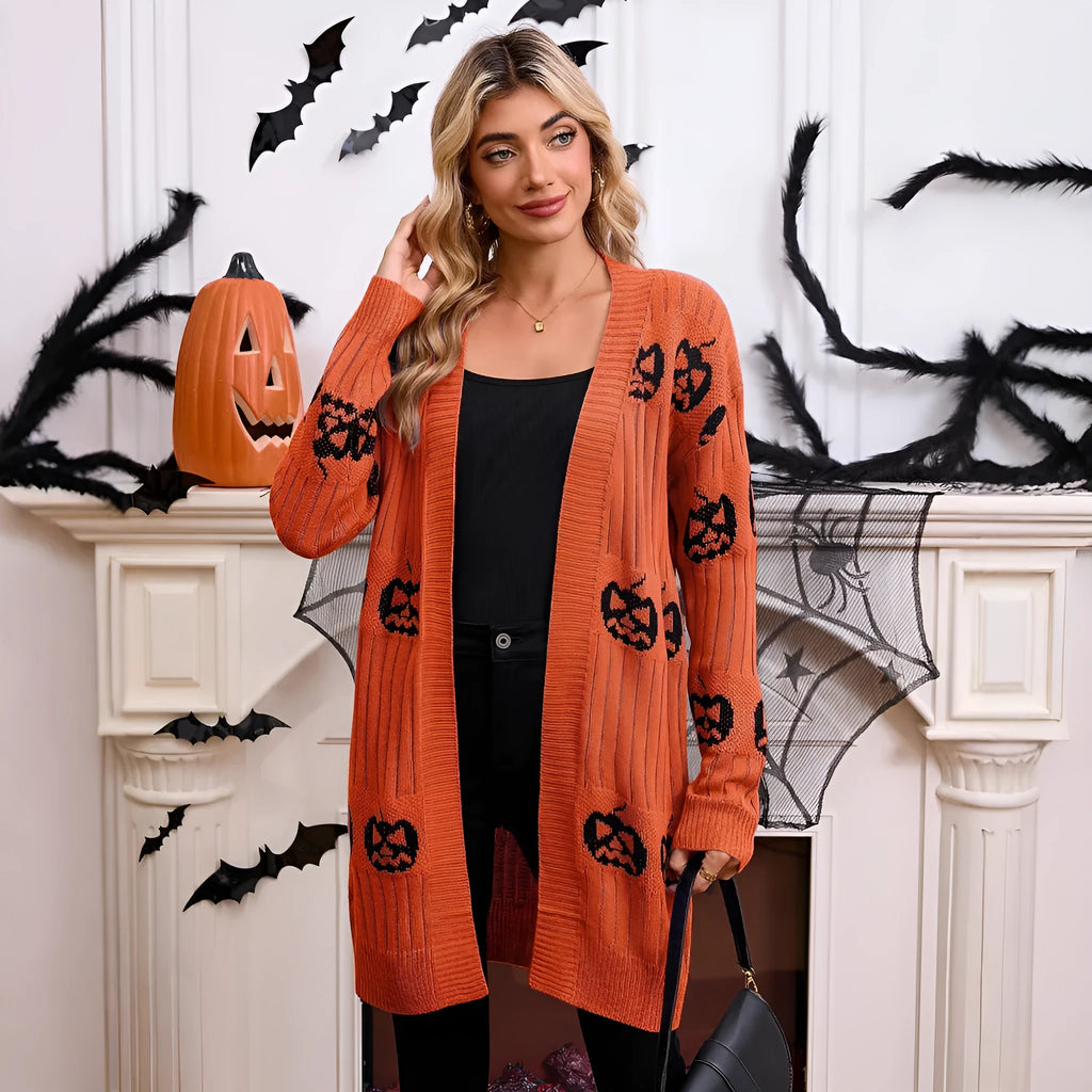 Women's black Halloween cardigan with orange pumpkin head jacquard pattern, shown as a straight-cut medium-length knit.