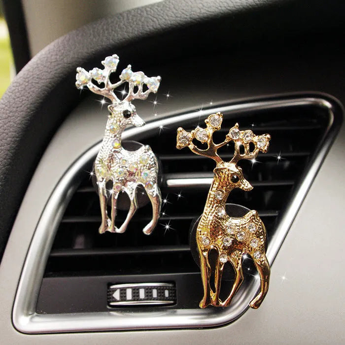 Alloy cartoon car air vent fragrance clip in one of twelve decorative styles.