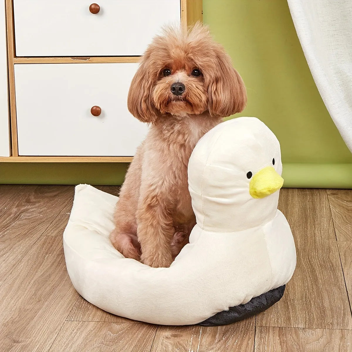Blue duck-shaped fluffy pet bed for a small dog on a wooden floor.