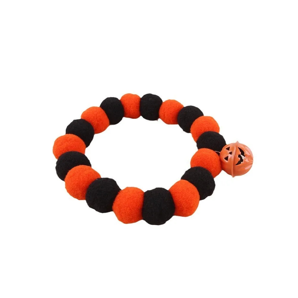 Orange Halloween pumpkin cat collar with green leaf on a breakaway safety buckle.
