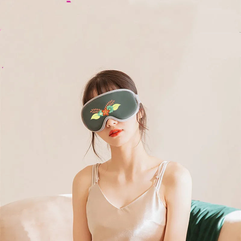 Pink and green portable heated eye mask with USB charging and vibration features for home and office use