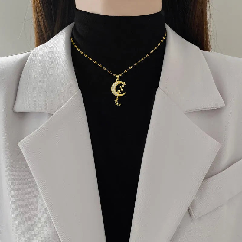 Moon pendant necklace with geometric tassel design and diamond arrangement on stainless steel chain