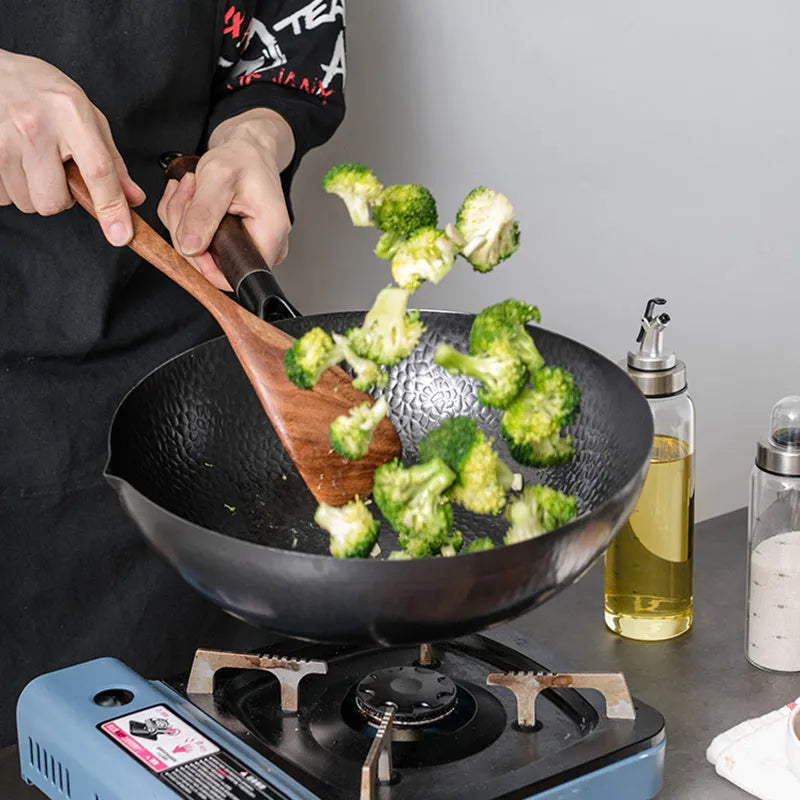 Black traditional iron wok with wooden handle measuring 40cm diameter