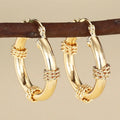Geometric copper ring ear clips for women in golden colour with linear design elements