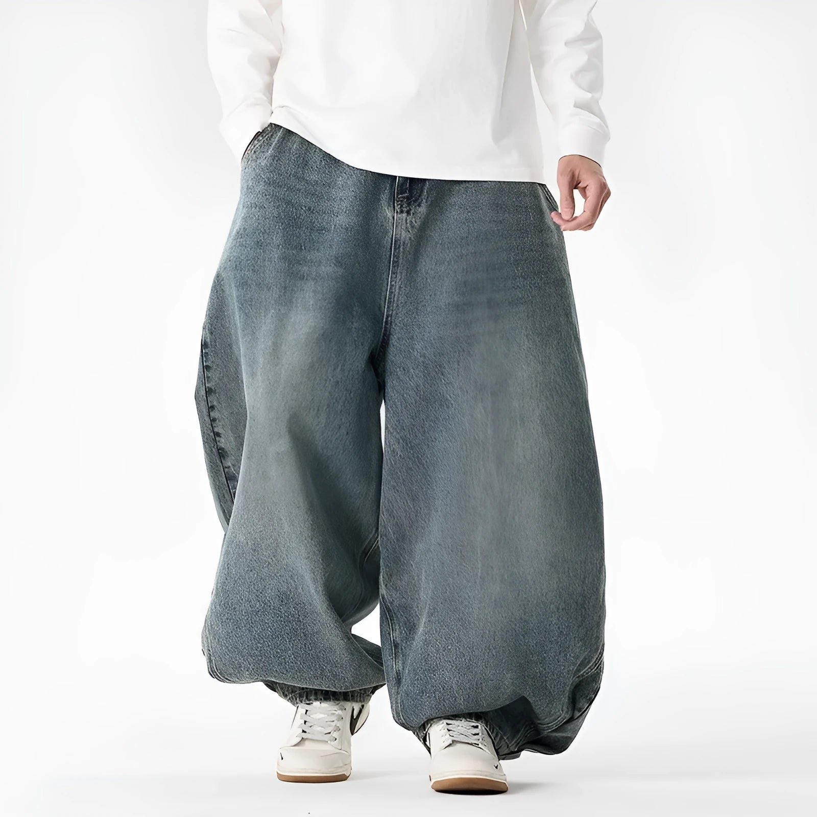 Men's plus size baggy blue jeans with wide straight legs on a hanger.