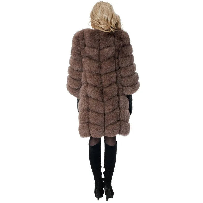 Women's long black artificial fur winter coat with regular sleeves on a hanger.