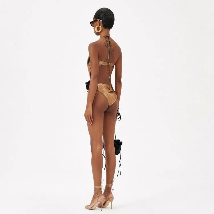 Gold halter neck one-piece swimsuit with hollow out design on mannequin