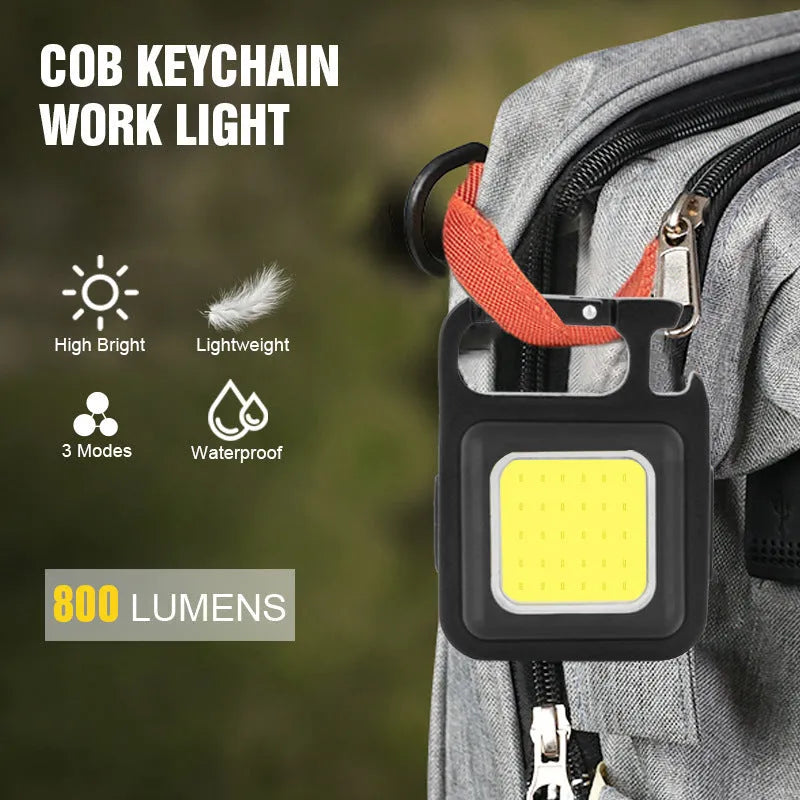 Black aluminum alloy USB rechargeable keychain light with magnetic base and foldable handle