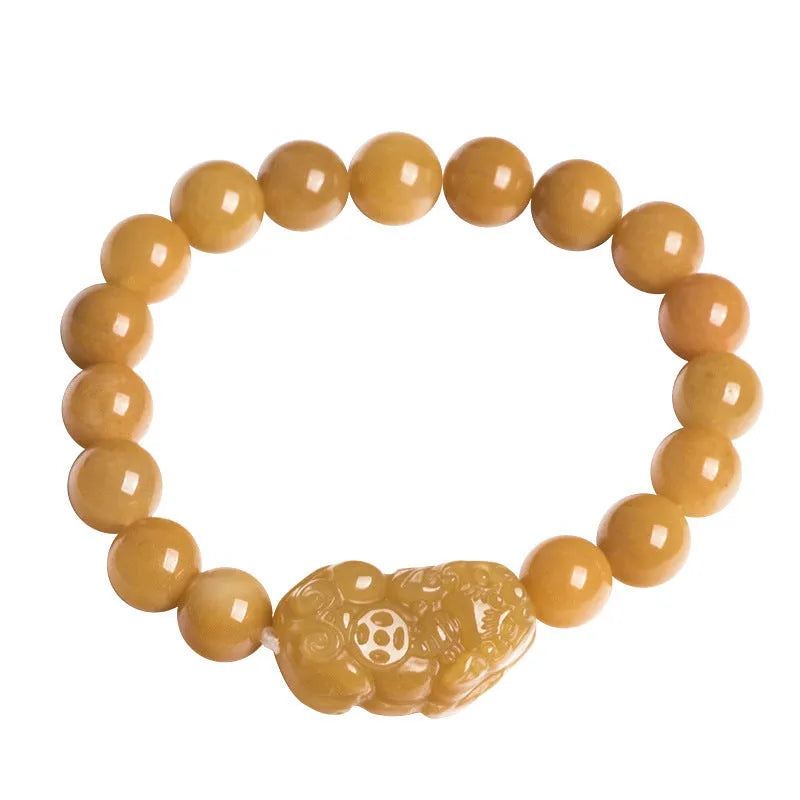 Hand-carved Golden Thread Jinsi Jade money bracelet showing carved detail, offered in large and small unisex sizes.
