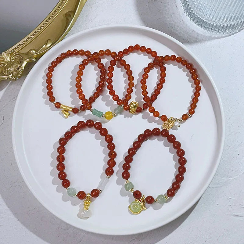 Handcrafted red agate bracelet for women with dragon charm, Chinese style design.