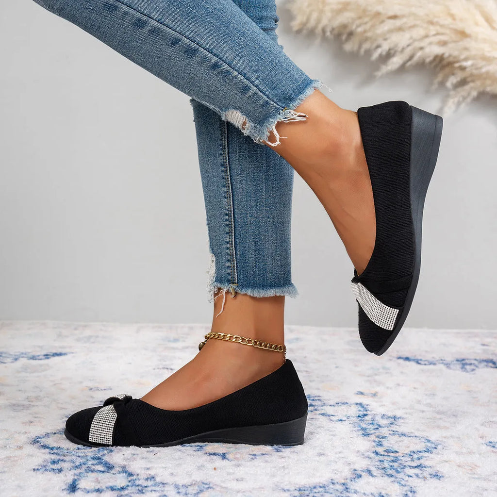 Black women's slip-on casual shoes with rhinestones on the toe and a chunky heel.