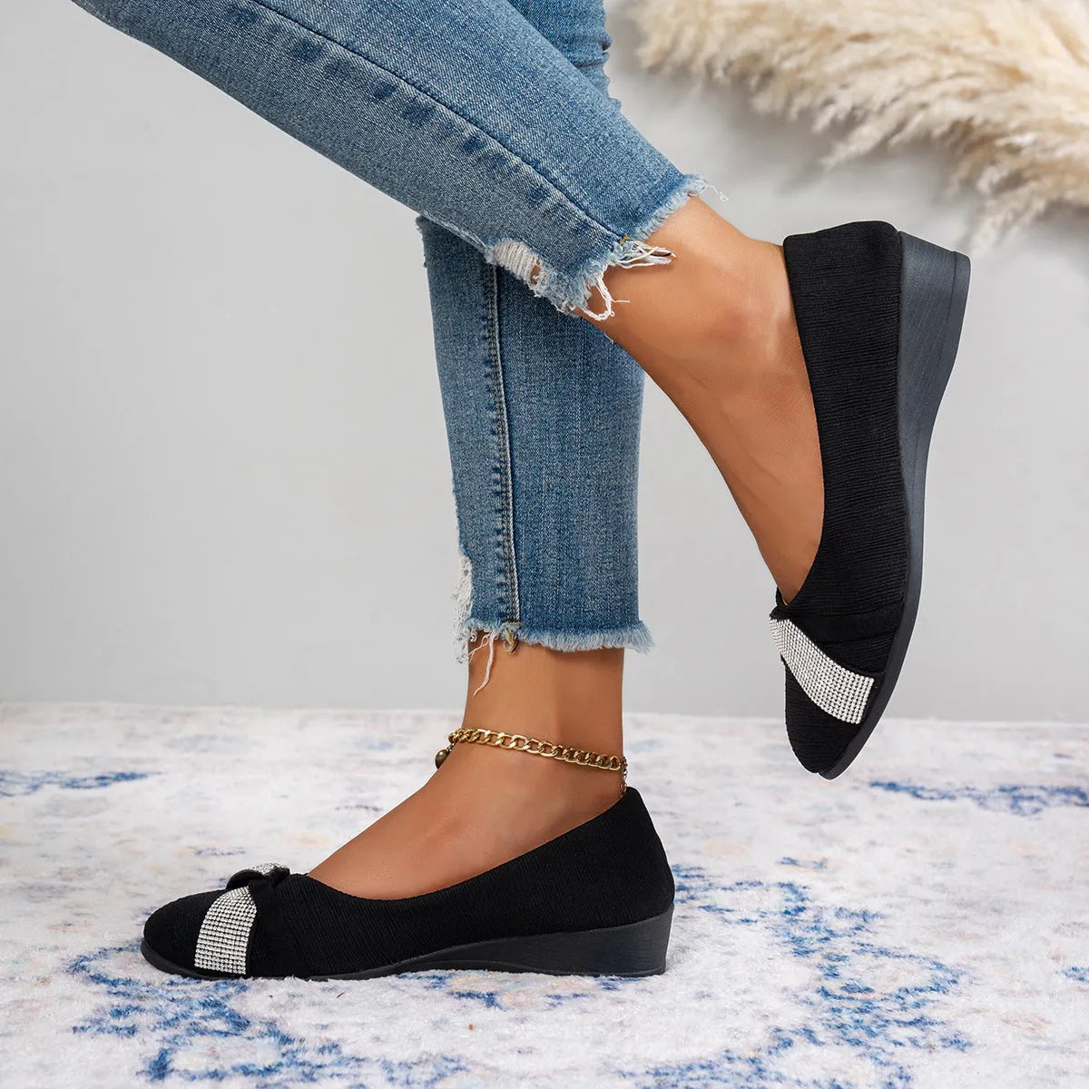 Black women's slip-on casual shoes with rhinestones on the toe and a chunky heel.