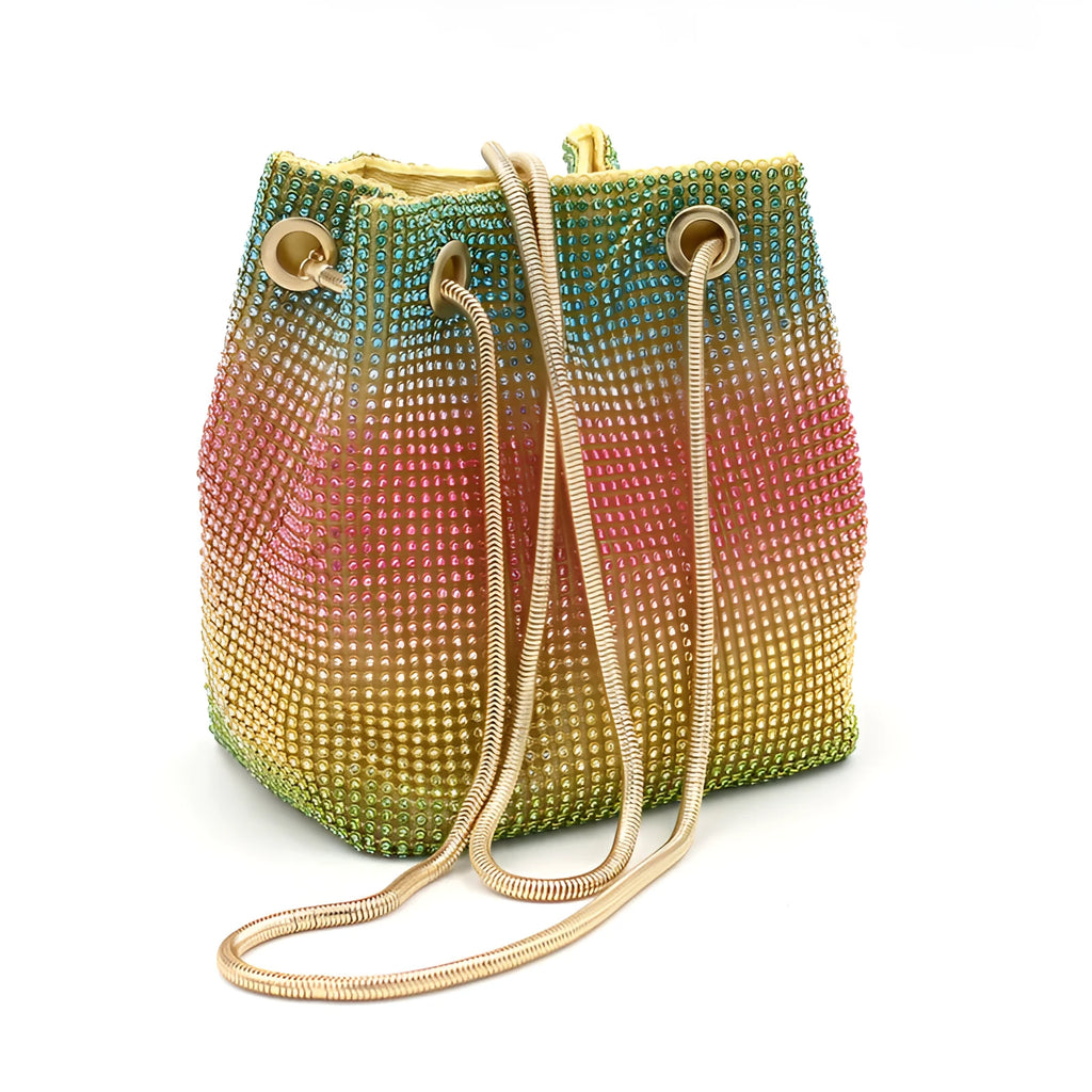 Rainbow coloured rhinestone bucket bag with a crossbody shoulder strap on a white background.