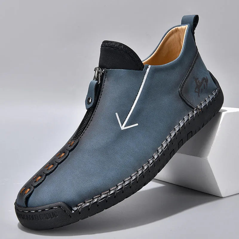 Men's black martin boot with front zipper and round toe on a rubber sole.